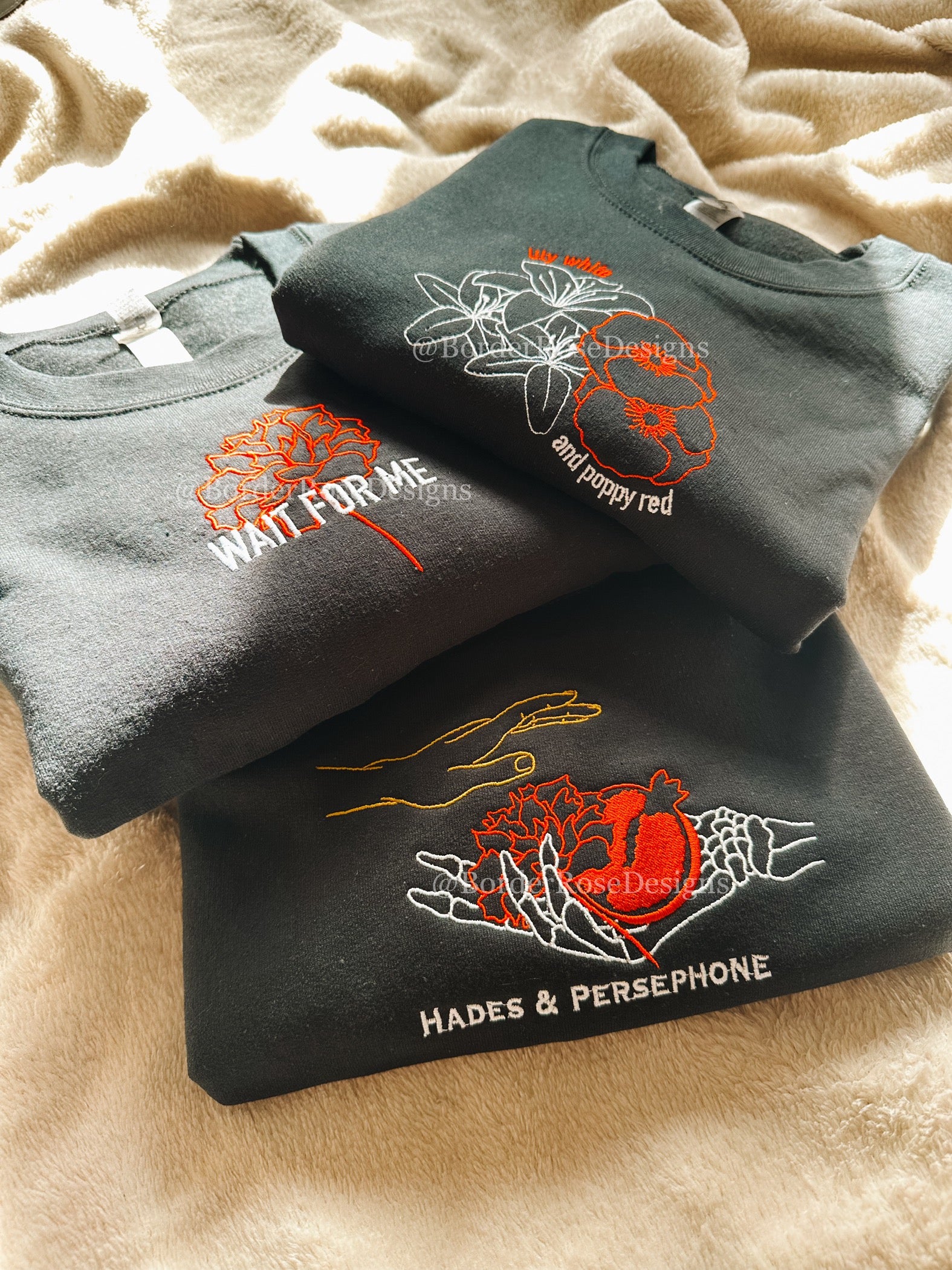 Lily White and Poppy Red Flowers Hadestown Unisex Embroidered Sweatshirt